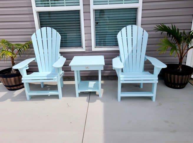 Pair of sky blue Adirondack chairs with a matching side table